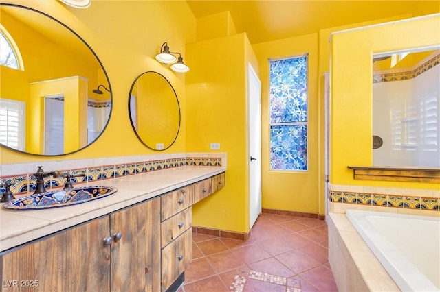 bathroom featuring a bath, baseboards, vanity, and tile patterned floors