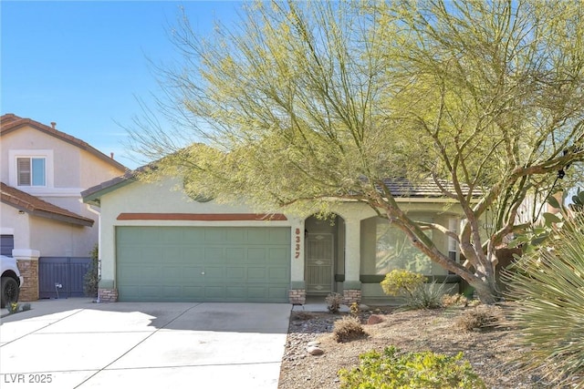 view of front of house with driveway, an attached garage, and stucco siding