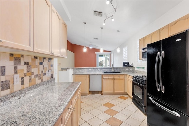 kitchen featuring light brown cabinets, a peninsula, a sink, visible vents, and black appliances