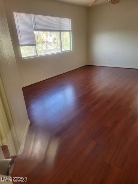 unfurnished room with dark wood-type flooring