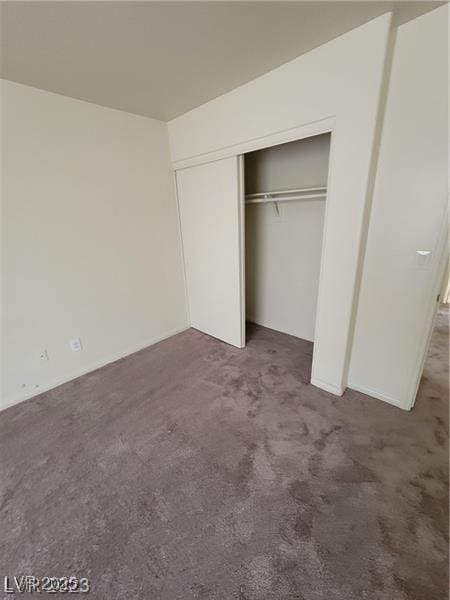 unfurnished bedroom with carpet floors and a closet