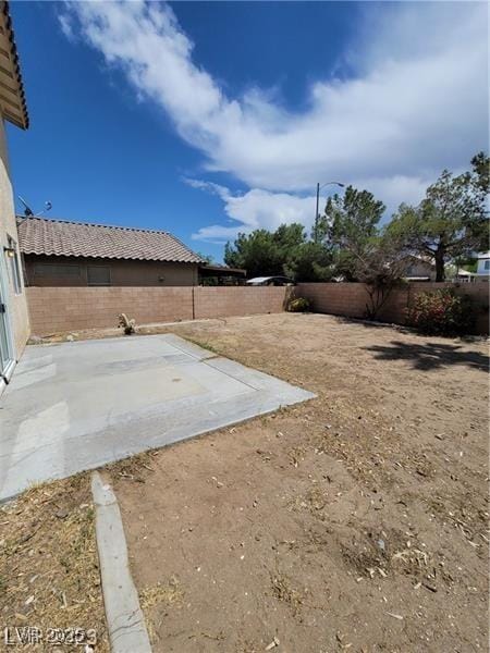 view of yard featuring a patio and a fenced backyard