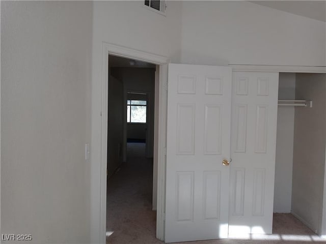 unfurnished bedroom with a closet, visible vents, and carpet flooring