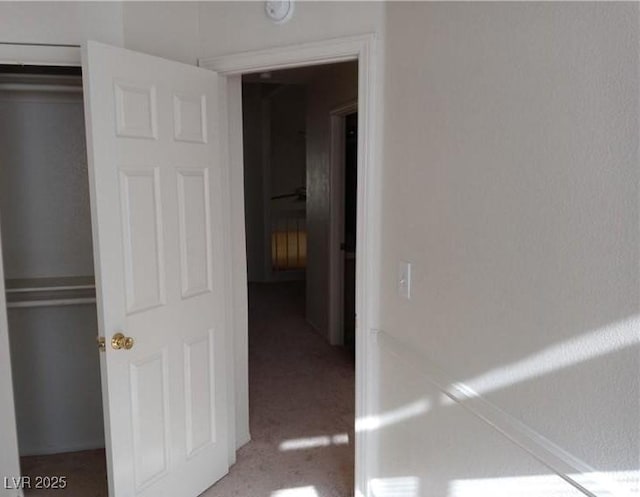 unfurnished bedroom with a closet and light colored carpet