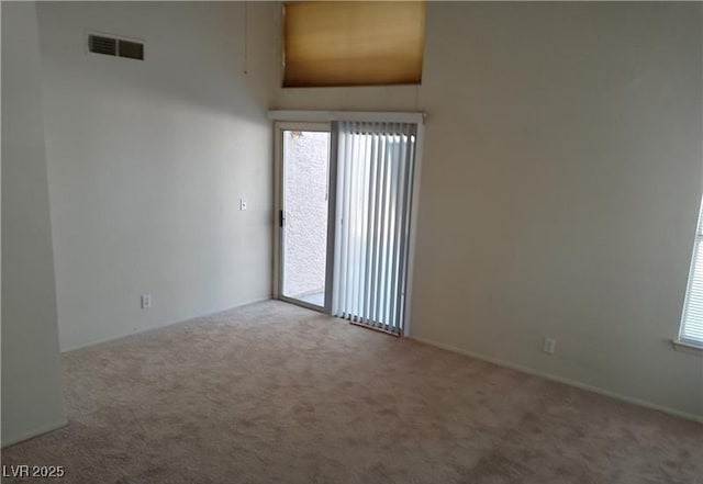 spare room featuring visible vents and carpet flooring