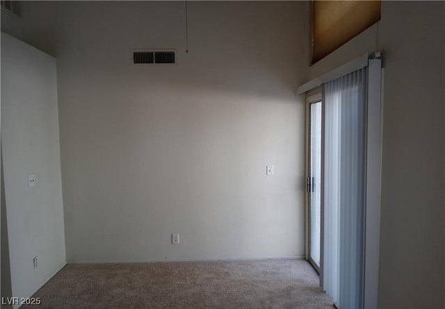 unfurnished room with carpet floors and visible vents