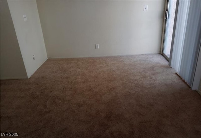 spare room featuring light colored carpet