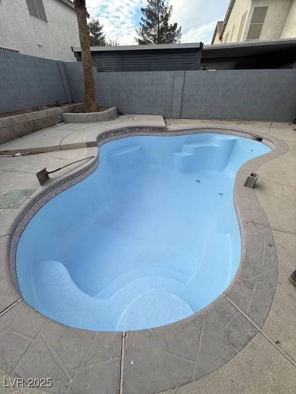 view of swimming pool featuring a fenced in pool, a fenced backyard, and a patio