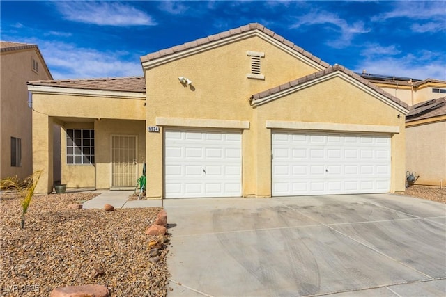 view of front of house with an attached garage, a tile roof, concrete driveway, and stucco siding