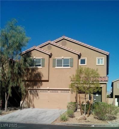 view of front of house featuring driveway, a tiled roof, and stucco siding