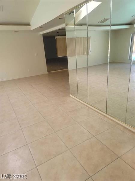 spare room featuring light tile patterned flooring