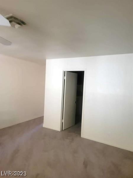 unfurnished room featuring carpet and visible vents