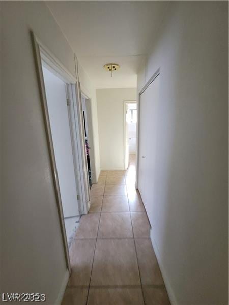 hall featuring light tile patterned floors