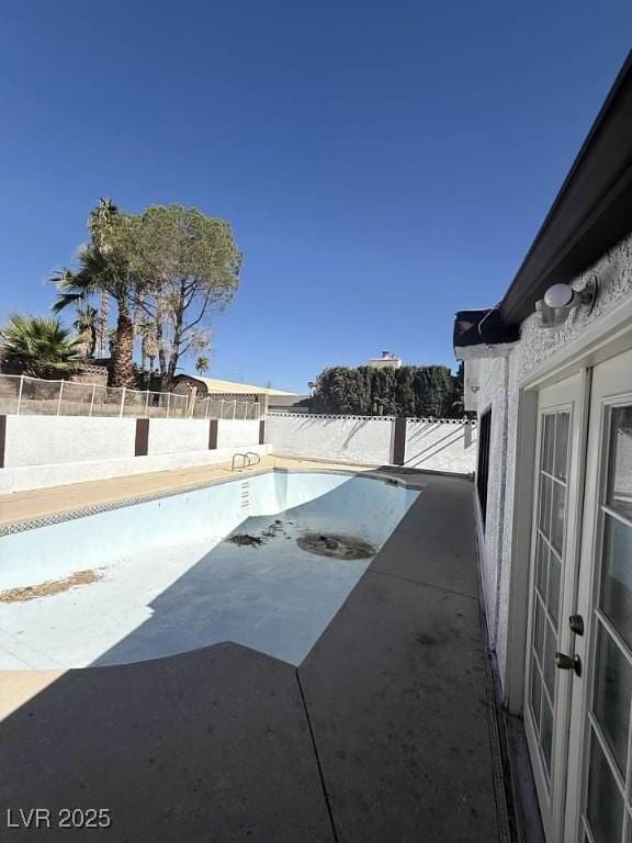 view of pool featuring a fenced backyard and a patio