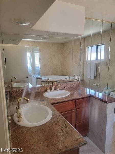 full bath featuring double vanity and a sink