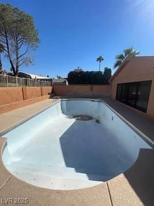 view of swimming pool with a fenced backyard