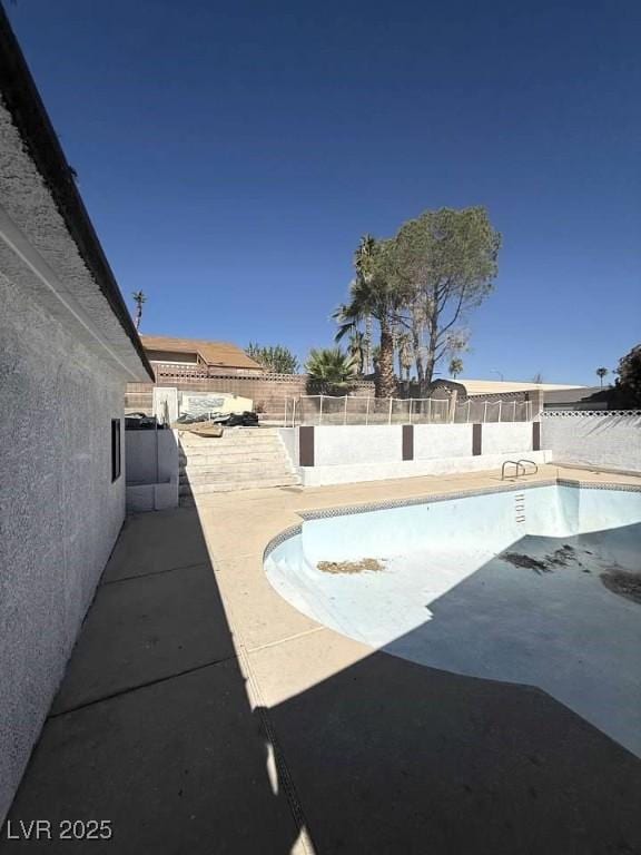 view of pool featuring a patio area, a fenced backyard, and a fenced in pool