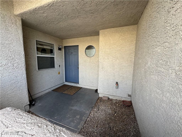 entrance to property with stucco siding