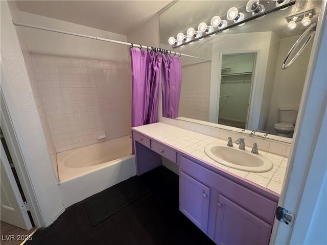 bathroom with shower / bath combo, vanity, and toilet