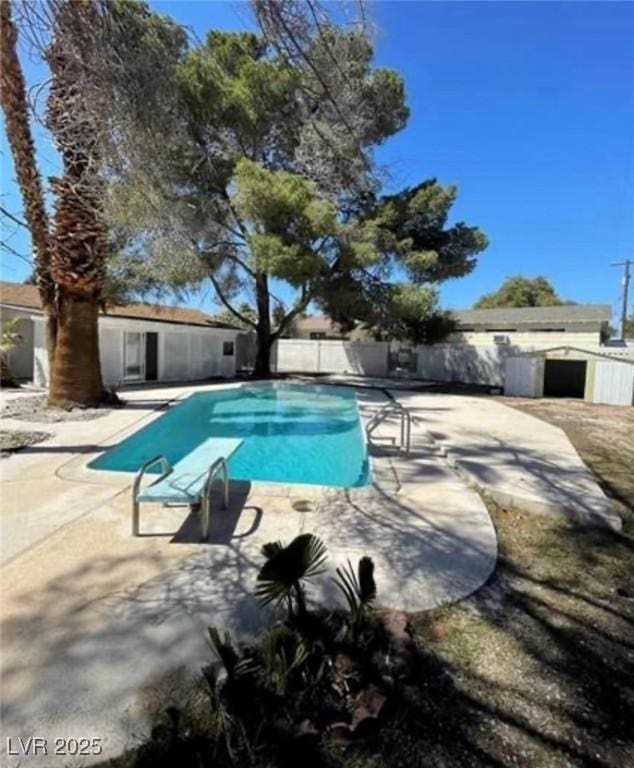 view of swimming pool featuring a patio area, fence, and a fenced in pool