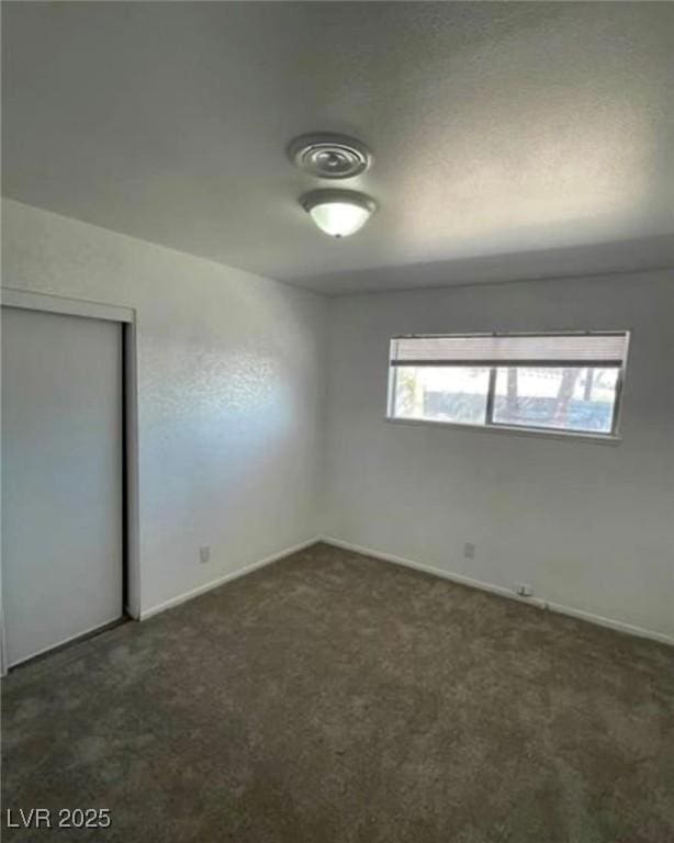 unfurnished bedroom featuring carpet floors and a closet