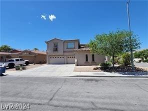 view of front of house with an attached garage and concrete driveway