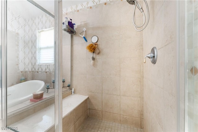 bathroom with a garden tub and a shower stall