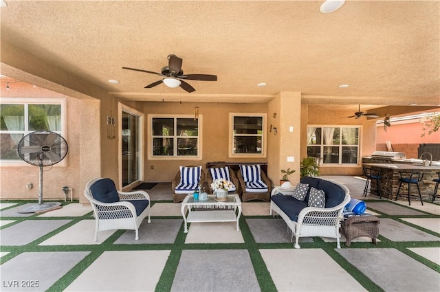 view of patio / terrace featuring a grill, an outdoor living space, and a ceiling fan