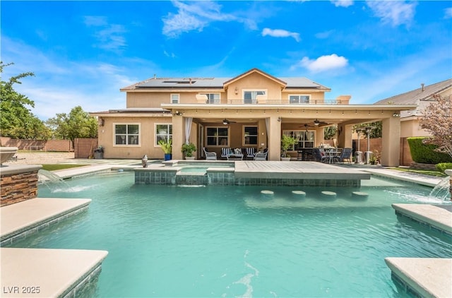 view of pool with a pool with connected hot tub, a fenced backyard, ceiling fan, and a patio