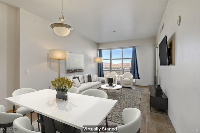 tiled dining area with visible vents and baseboards