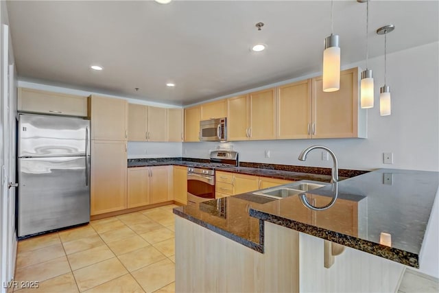 kitchen with light tile patterned flooring, light brown cabinets, stainless steel appliances, a peninsula, and a sink