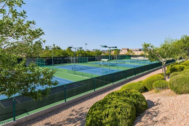 view of tennis court featuring fence