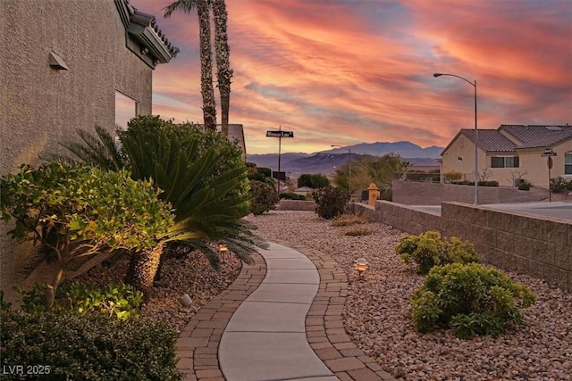 view of home's community featuring fence and a mountain view