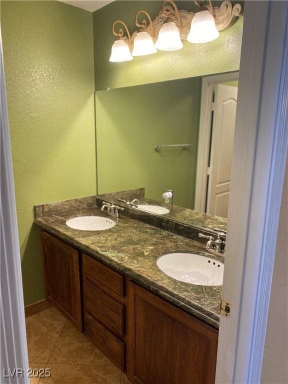 bathroom featuring double vanity, a sink, and tile patterned floors