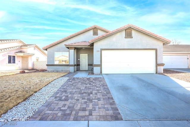 view of front of property with a garage, concrete driveway, and stucco siding