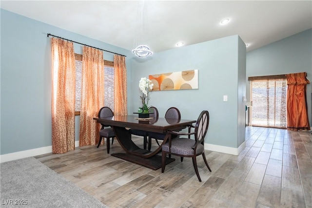 dining space featuring lofted ceiling, baseboards, wood finished floors, and recessed lighting