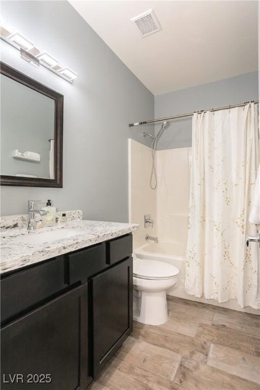 full bath featuring toilet, wood finished floors, vanity, visible vents, and shower / tub combo with curtain