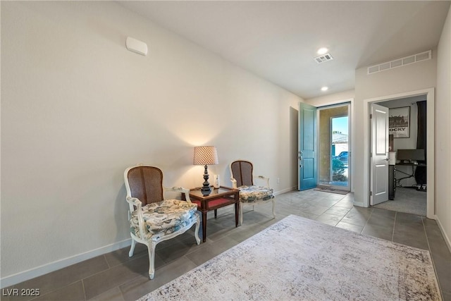 living area with recessed lighting, baseboards, visible vents, and tile patterned floors