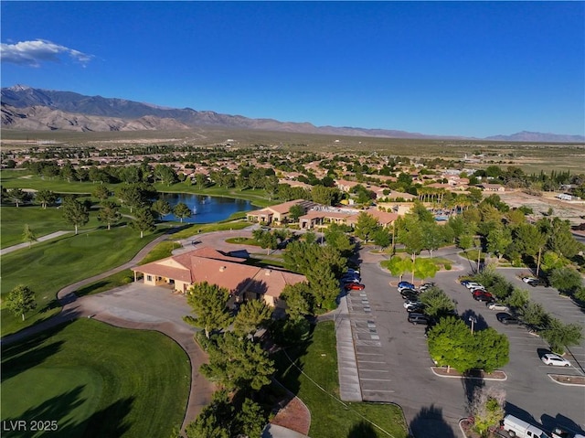 birds eye view of property with golf course view and a water and mountain view