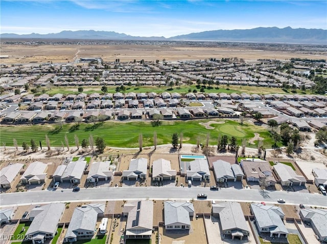 drone / aerial view featuring view of golf course, a residential view, and a mountain view