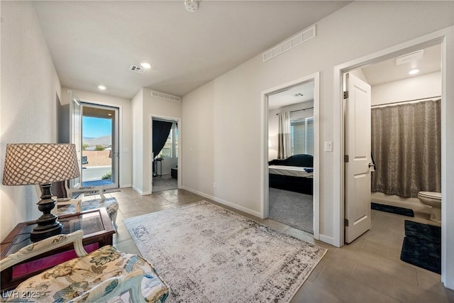 hallway with recessed lighting, visible vents, and baseboards