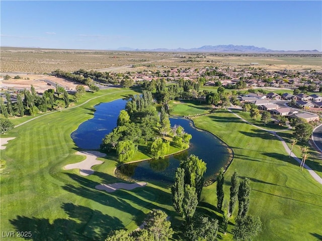 bird's eye view featuring view of golf course and a water and mountain view