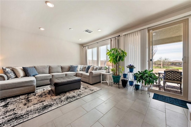 tiled living area with visible vents and recessed lighting