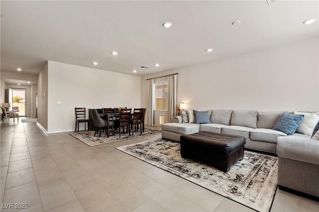 living area with baseboards, a wealth of natural light, and recessed lighting