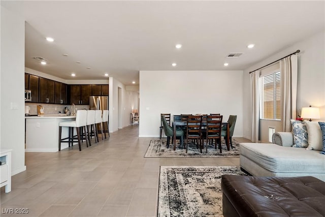 living room with recessed lighting, visible vents, baseboards, and light tile patterned floors