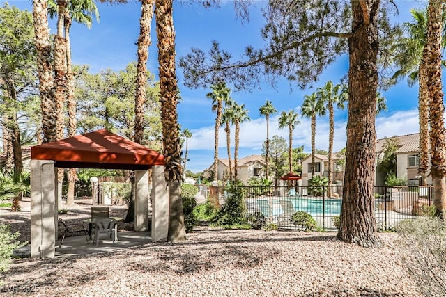 view of home's community featuring a gazebo, fence, a residential view, and a patio