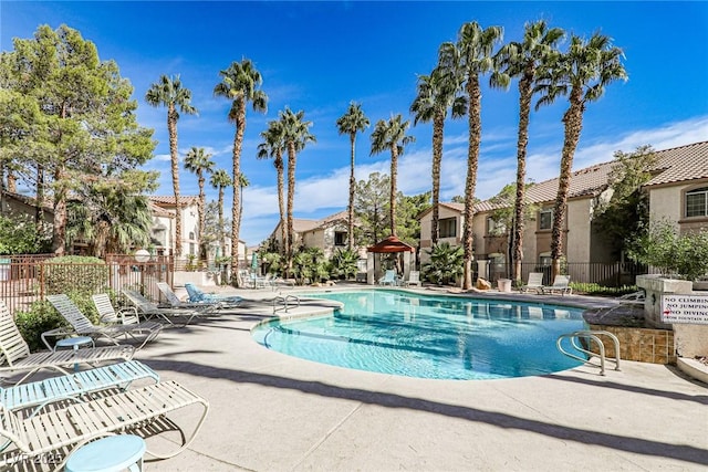 pool featuring a patio area, a residential view, and fence