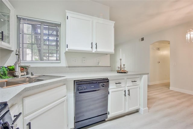 kitchen featuring visible vents, arched walkways, a sink, black dishwasher, and white cabinetry