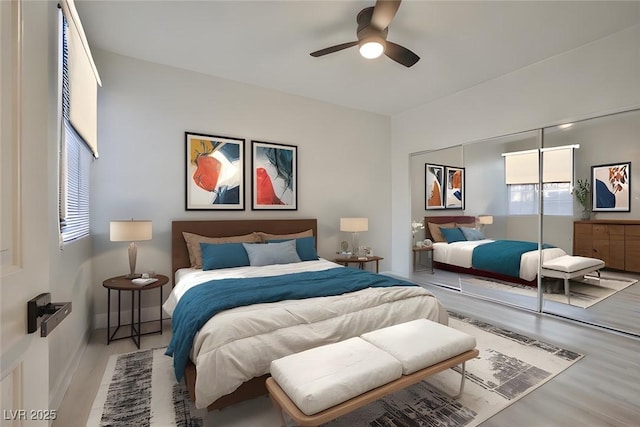 bedroom featuring a closet, baseboards, wood finished floors, and a ceiling fan