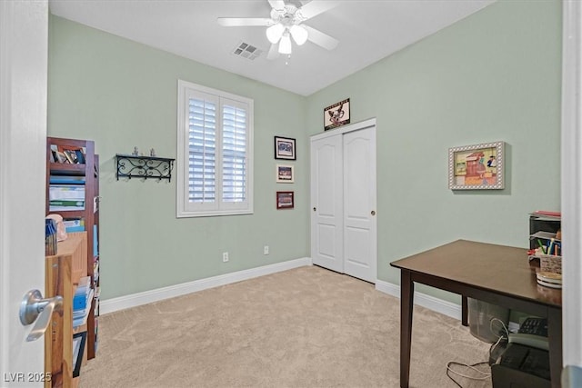 home office with a ceiling fan, carpet, visible vents, and baseboards